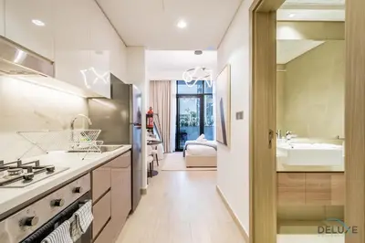a large kitchen with a sink and a tub at Stylish Studio Apartment in Azizi Riviera 37 Al Merkadh by Deluxe Holiday Homes in Dubai