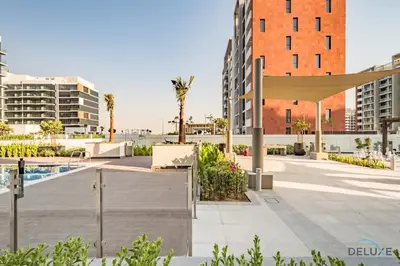 a view of a courtyard with a pool and buildings at Stylish Studio Apartment in Azizi Riviera 37 Al Merkadh by Deluxe Holiday Homes in Dubai