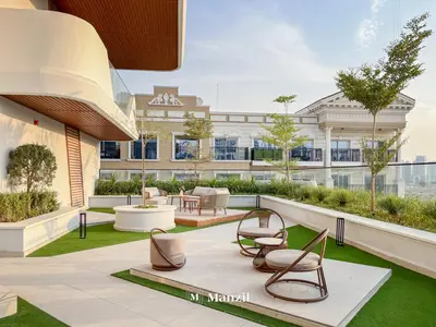 an outdoor patio with chairs and a building at Manzil - 1BR Apartment in Marquis Signature with City Views in Dubai