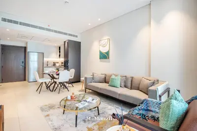 a living room with a couch and a table at Manzil - 1BR Apartment in Marquis Signature with City Views in Dubai