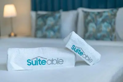two towels on a bed in a hotel room at Peaceful flat in Motor City in Dubai