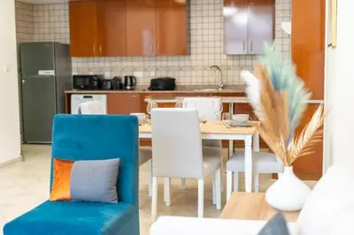 a kitchen with a table and chairs in a kitchen at Peaceful flat in Motor City in Dubai