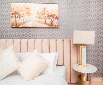 a bedroom with a bed and a painting on the wall at Elite Royal Apartment - Sky Series - Ful Burj Khalifa & Fountain View - Prodigy in Dubai