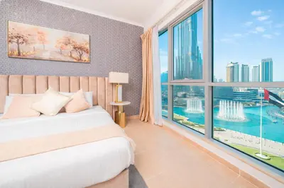 a bedroom with a bed and a large window at Elite Royal Apartment - Sky Series - Ful Burj Khalifa & Fountain View - Prodigy in Dubai