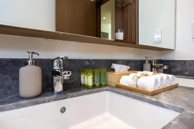 a bathroom with a sink and two faucets at Waves - 52 42 Emaar, Tower 1 in Dubai