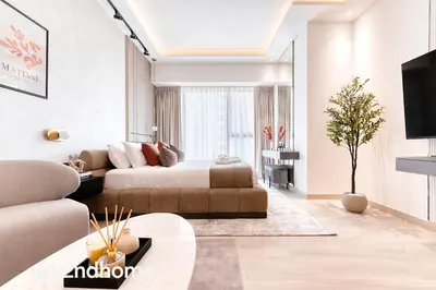 a living room with a bed and a couch at 2ndHome - Me Do Re , Cluster L, JLT in Dubai