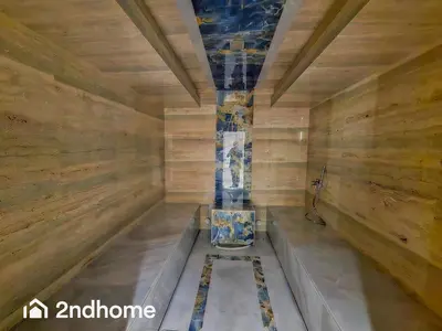 a room with a toilet in a room with wooden walls at 2ndHome - Me Do Re , Cluster L, JLT in Dubai