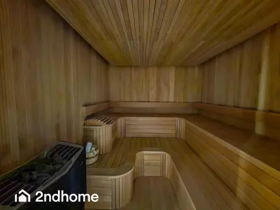 an empty sauna with wooden floors and a wooden ceiling at 2ndHome - Me Do Re , Cluster L, JLT in Dubai
