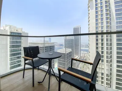 a balcony with a table and chairs on a building at Silkhaus Sea View Stunning 1BDR with Private Beach in Dubai
