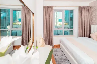 a bedroom with a bed and large windows at Elite Royal Apartment - Full Burj Khalifa & Fountain View - Luxurious - Viceroy in Dubai