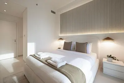 a bedroom with a large white bed with towels on it at Burj Crown - Downtown Elegance Opera Boulevard View by Dubai Mall in Dubai