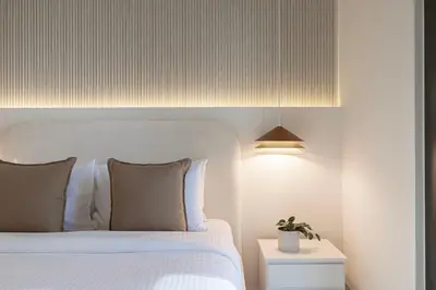 a bedroom with a white bed and a lamp at Burj Crown - Downtown Elegance Opera Boulevard View by Dubai Mall in Dubai