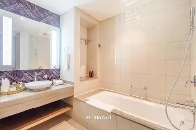 a bathroom with a tub and a sink at Manzil - 1BR Apartment in Paramount with Top-Floor Luxury Living in Dubai