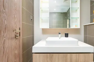 a bathroom with a white sink and a mirror at Vacay Lettings - Liv Residence in Dubai