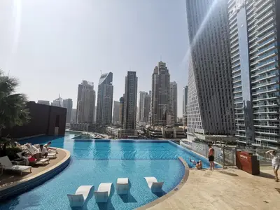 a swimming pool with a city skyline in the background at Vacay Lettings - Liv Residence in Dubai