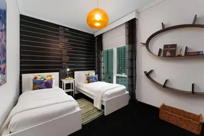 a bedroom with two beds and a mirror at Maison Privee - Cosmopolitan Apt with Scenic Dubai Marina Vws in Dubai