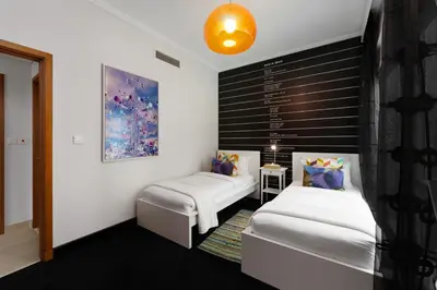 a bedroom with two beds and a black and white wall at Maison Privee - Cosmopolitan Apt with Scenic Dubai Marina Vws in Dubai