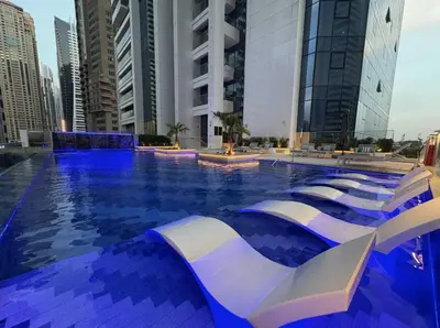 a swimming pool in a city with tall buildings at SettlerHomes - Upscale JLT Stay Near Metro in Dubai