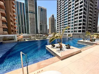 a swimming pool in a city with tall buildings at SettlerHomes - Upscale JLT Stay Near Metro in Dubai