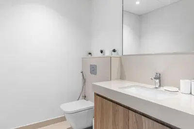 a white bathroom with a toilet and a sink at New Stunning 4 BR Burj Khalifa View in Dubai