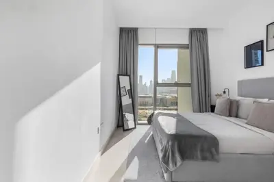 a bedroom with a bed and a large window at New Stunning 4 BR Burj Khalifa View in Dubai