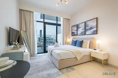 a bedroom with a large bed and a large window at Delightful Studio Apartment in Azizi Riviera 20, Al Merkadh by Deluxe Holiday Homes in Dubai