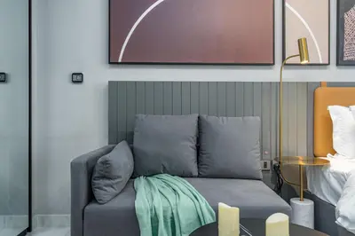 a couch sitting in a living room next to a table at Vacay Lettings - MAG -318 in Dubai
