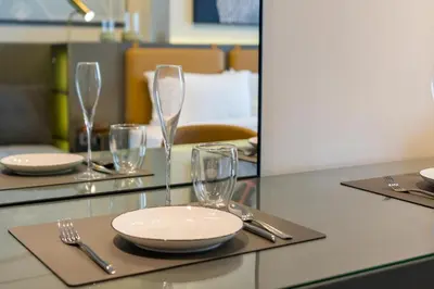 a table with plates and glasses on top of it at Vacay Lettings - MAG -318 in Dubai