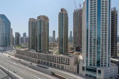 a city skyline with tall buildings and a highway at Vacay Lettings - MAG -318 in Dubai