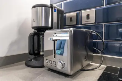 a food processor sitting on a counter next to a mixer at Vacay Lettings - MAG -318 in Dubai