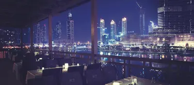a restaurant with a view of a city at night at Vacay Lettings - MAG -318 in Dubai