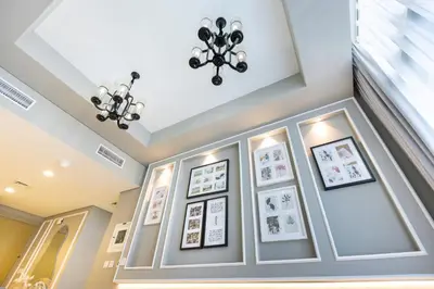a room with pictures on the wall and a chandelier at Cozy 1 BR apartment in Dubai near Burj khalifa in Dubai