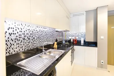 a kitchen with a sink and a counter top at Cozy 1 BR apartment in Dubai near Burj khalifa in Dubai