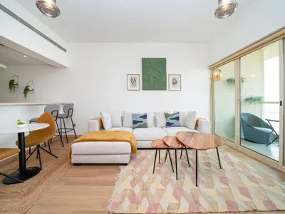 a living room with a couch and a table at Stylish One Bedroom Sanctuary in the Greens in Dubai