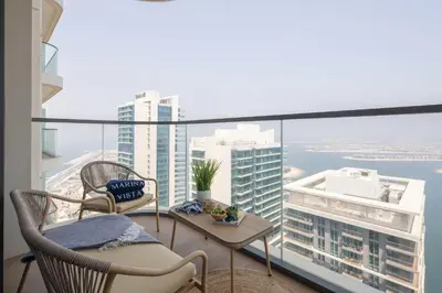 a balcony with chairs and a view of the city at Frank Porter - Marina Vista Tower 2 in Dubai