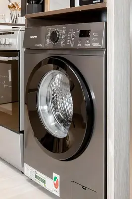 a washing machine in a kitchen next to a stove at Apartments in ME DO RE Jumeirah Lake Towers in Dubai