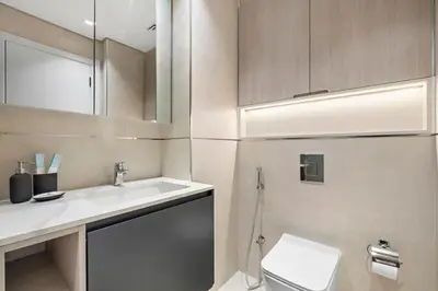 a bathroom with a sink and a toilet at StoneTree - Modern Apartment - Brand New in Dubai