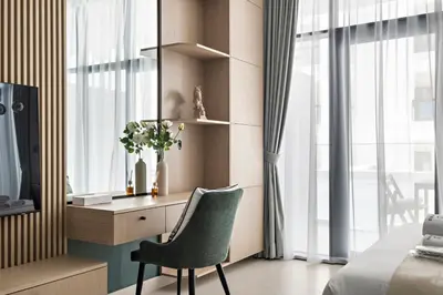 a bedroom with a desk and a chair next to a window at StoneTree - Modern Apartment - Brand New in Dubai