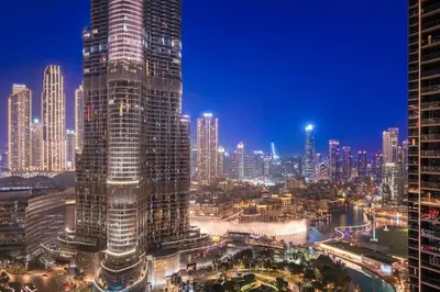 a city skyline with tall skyscrapers at night at FIRST CLASS 1BR Burj Khalifa & Fountain Views in Dubai