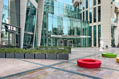 a large building with a red bowl in front of it at FIRST CLASS 1BR Burj Khalifa & Fountain Views in Dubai