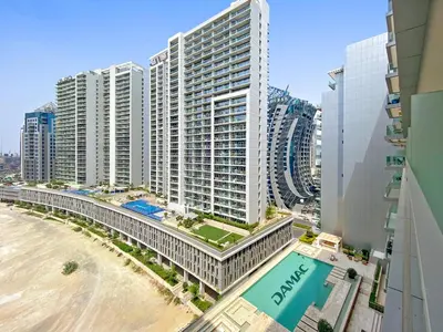 a view of a large building next to a beach at Spacious Studio in Business Bay in Dubai