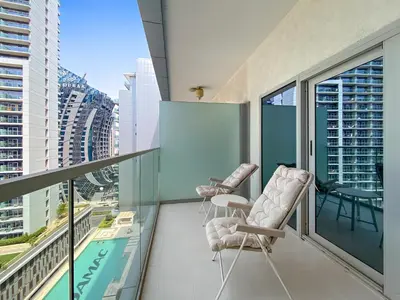 a balcony with two chairs and a view of the city at Spacious Studio in Business Bay in Dubai