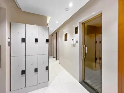 a hallway with white lockers in a building at Spacious Studio in Business Bay in Dubai