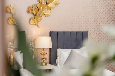 a bedroom with a bed with a lamp on a table at Elite Royal Apartment - Full Burj Khalifa & Fountain View - Luxury Edition - Strategos in Dubai