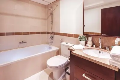 a bathroom with a toilet and a tub and a sink at Elite Royal Apartment - Full Burj Khalifa & Fountain View - Luxury Edition - Strategos in Dubai