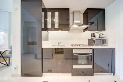 a kitchen with a counter with a sink and a microwave at Business Bay Studio in hotel l Sleek & Modern for 2 in Dubai