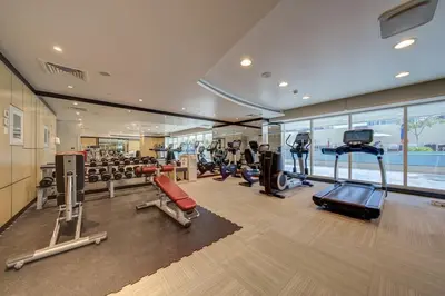 a gym with several treadmills and elliptical machines at Business Bay Studio in hotel l Sleek & Modern for 2 in Dubai