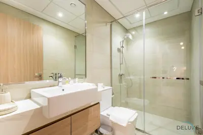 a bathroom with a sink and a shower and a toilet at Captivating 1BR Apartment in Azizi Riviera 20, Al Merkadh by Deluxe Holiday Homes in Dubai