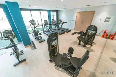 an overhead view of a gym with cardio equipment at Captivating 1BR Apartment in Azizi Riviera 20, Al Merkadh by Deluxe Holiday Homes in Dubai