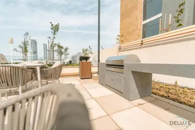 a balcony with a table and chairs on a building at Captivating 1BR Apartment in Azizi Riviera 20, Al Merkadh by Deluxe Holiday Homes in Dubai